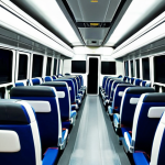 A serene and comfortable interior view of a modern Brazilian 'leito' long-distance bus. The focus is on a spacious, fully reclined seat, demonstrating the ultimate comfort and bed-like configuration. A clean, soft blanket and a small, inviting pillow are neatly placed on the seat. Subtle, professional ambient lighting from overhead fixtures illuminates the well-maintained, spotless cabin. The overall atmosphere conveys a peaceful, relaxing, and professional travel experience designed for long journeys. safe for work, appropriate content, fully clothed, professional, modest, family-friendly, perfect anatomy, correct proportions, natural pose, well-formed hands, proper finger count, natural body proportions, high-quality photography, sharp focus, inviting atmosphere.